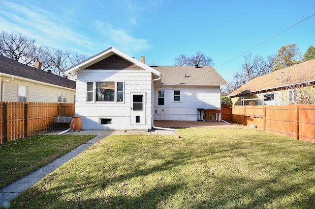 back of property with a patio area and a yard