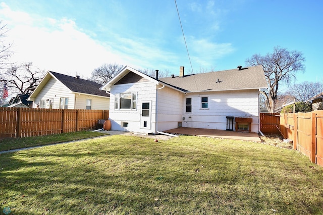 back of house with a lawn and a patio area