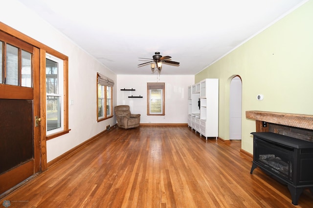 unfurnished living room with hardwood / wood-style floors, ceiling fan, and crown molding