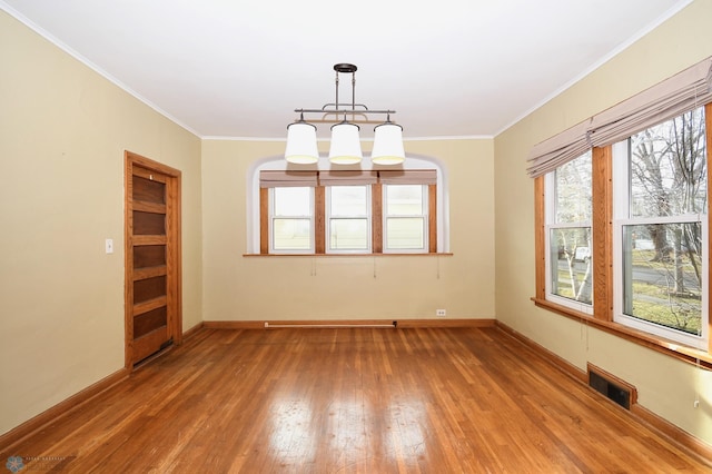 unfurnished room with hardwood / wood-style flooring and ornamental molding