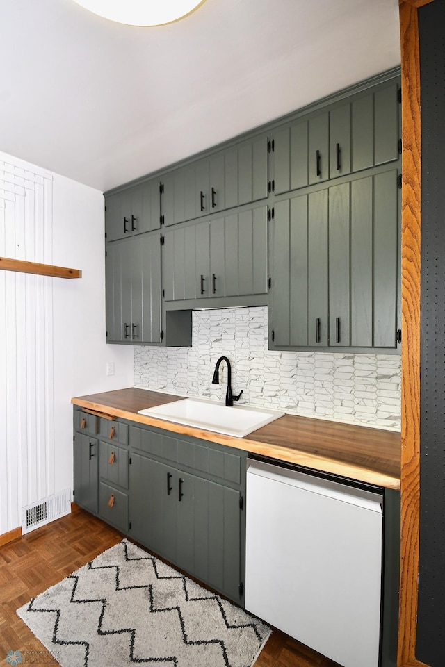 kitchen featuring dark parquet flooring, dishwasher, sink, backsplash, and butcher block countertops