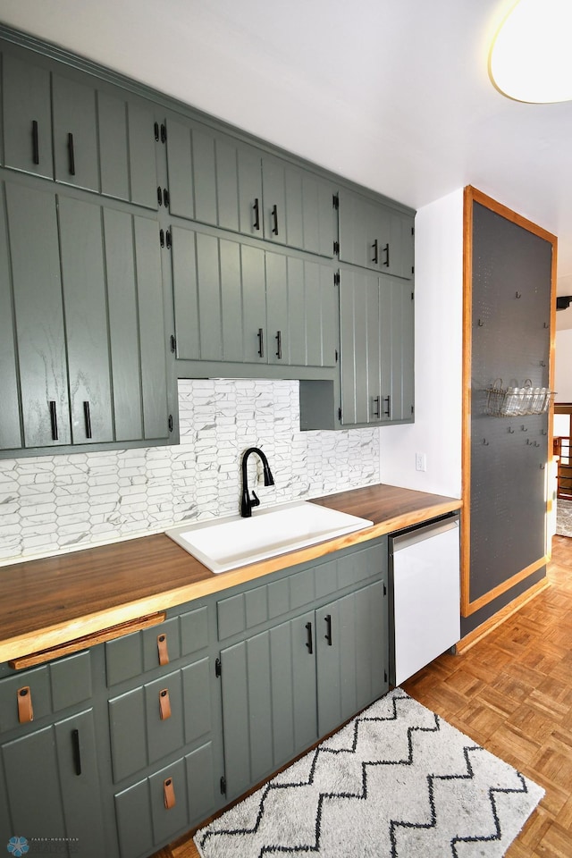 kitchen featuring tasteful backsplash, dishwashing machine, light parquet floors, sink, and butcher block countertops