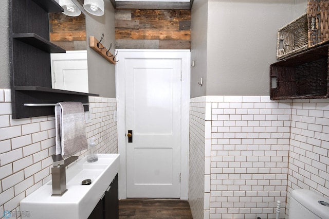 kitchen featuring dark hardwood / wood-style floors and tile walls