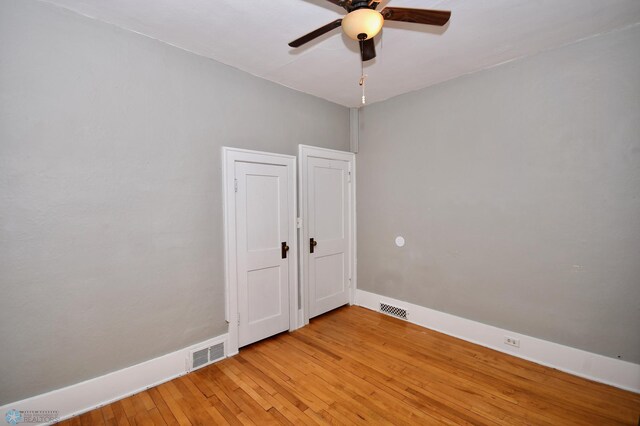 empty room with light wood-type flooring and ceiling fan