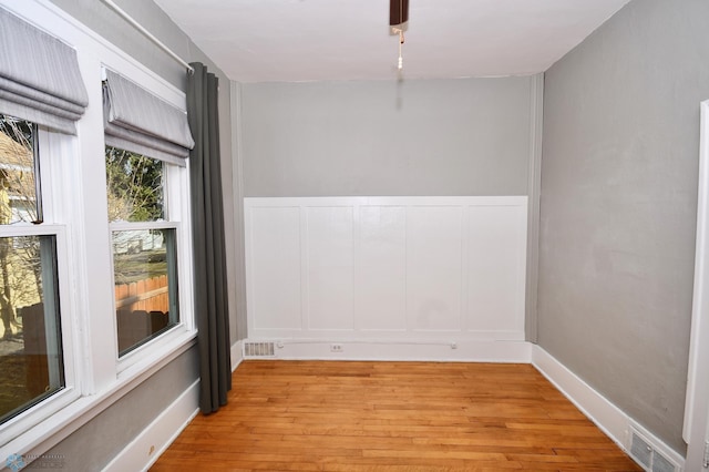 empty room with light hardwood / wood-style flooring