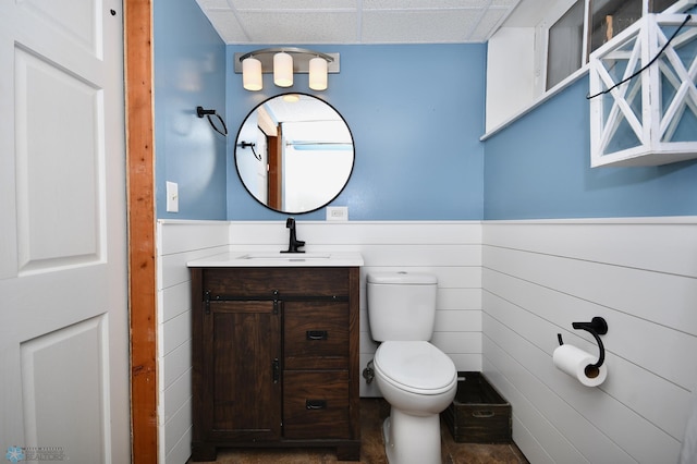 bathroom featuring vanity, toilet, and a paneled ceiling