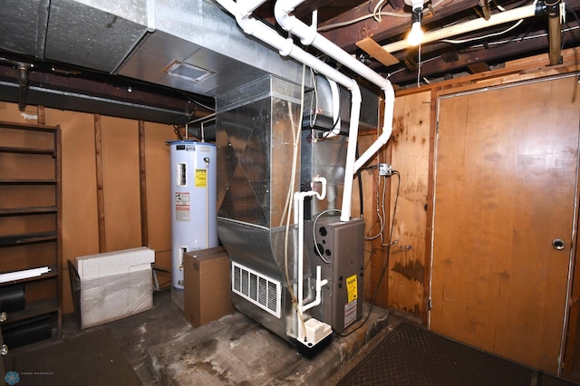 utility room with heating unit and gas water heater