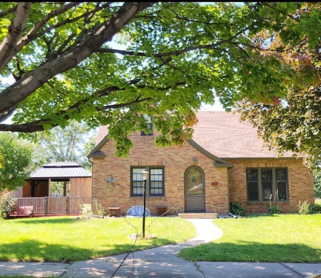 english style home with a front yard