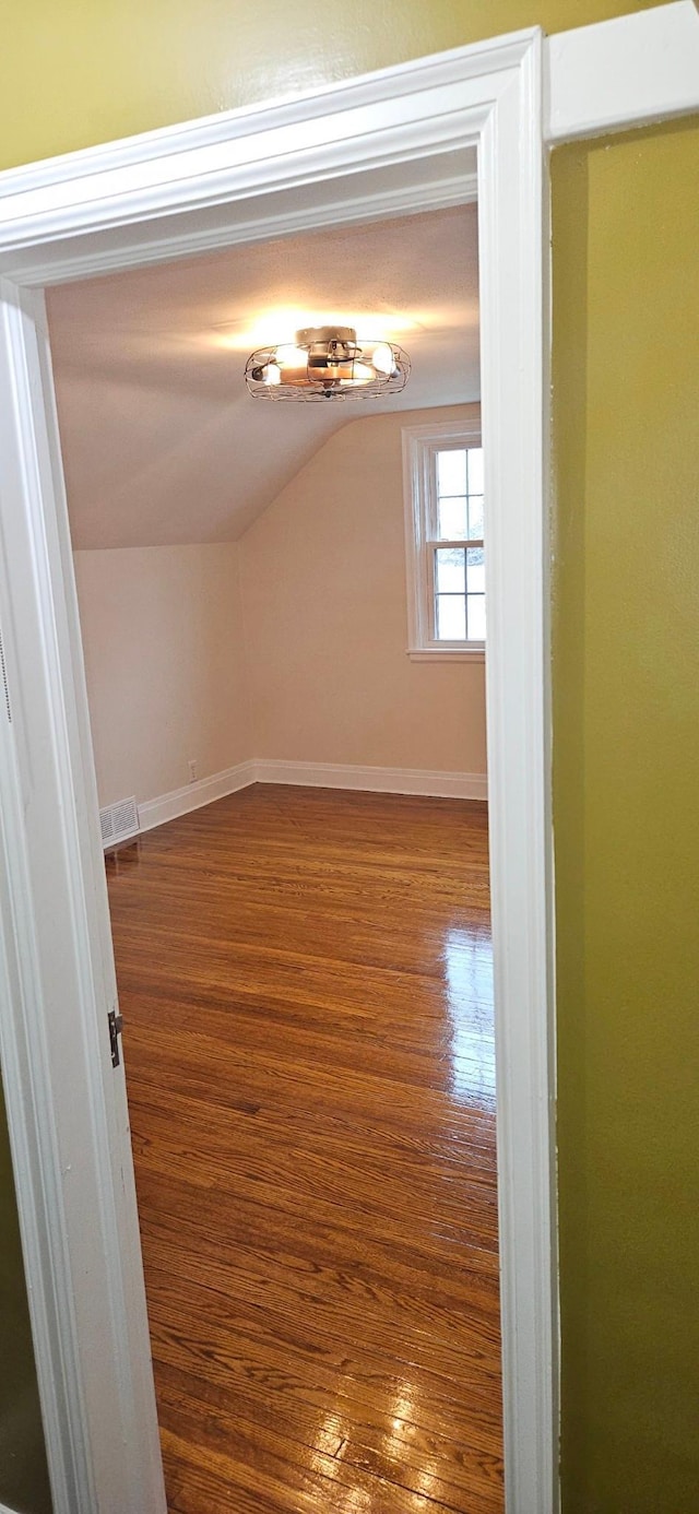 bonus room with wood-type flooring