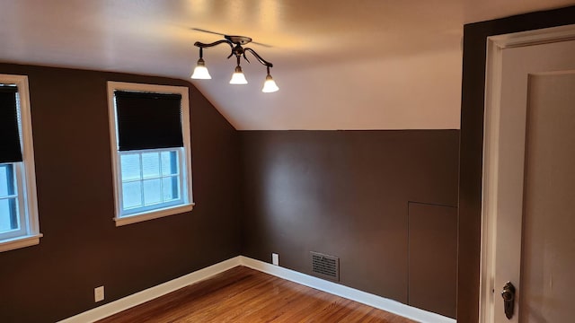 bonus room featuring hardwood / wood-style floors and lofted ceiling