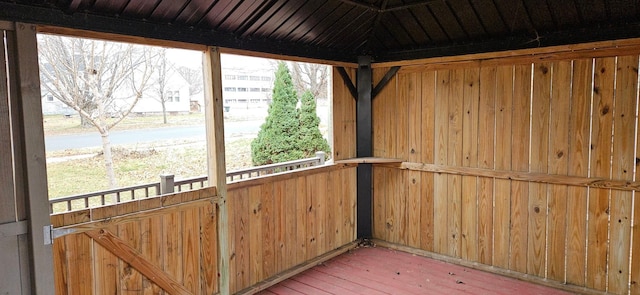 unfurnished sunroom with wooden ceiling and a wealth of natural light