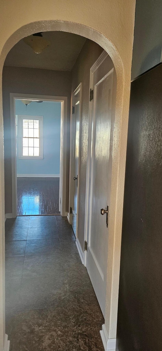 hallway with dark hardwood / wood-style flooring