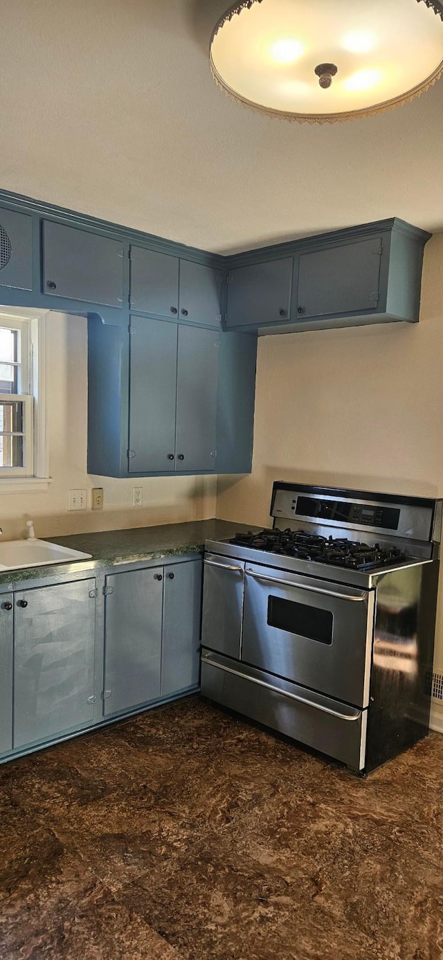 kitchen featuring gas stove and sink