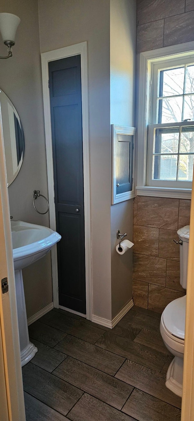 bathroom featuring wood-type flooring and toilet