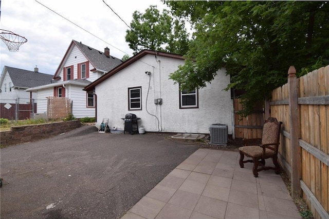 rear view of house with a patio and central AC unit