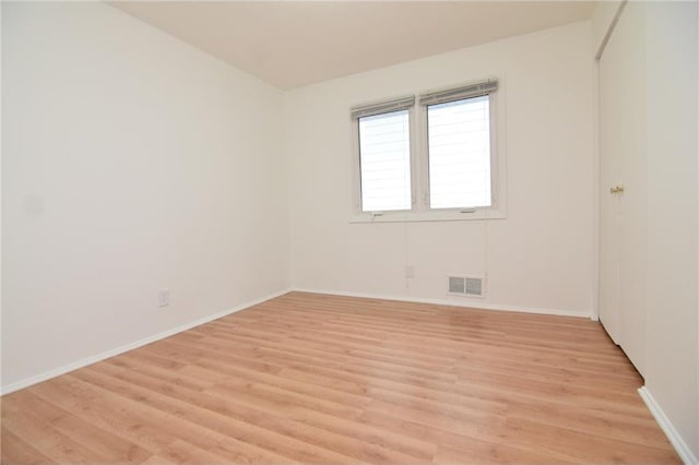 spare room with light wood-type flooring