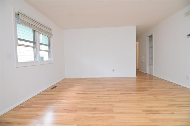 spare room with light hardwood / wood-style floors