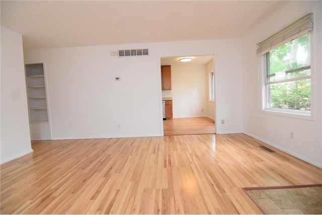 unfurnished room featuring light wood-type flooring