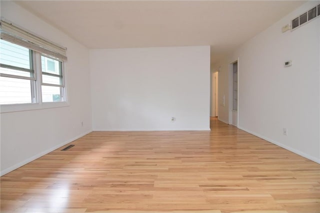 unfurnished room with light wood-type flooring