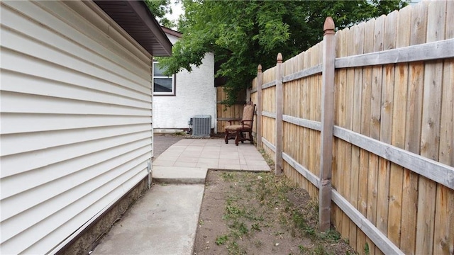 view of yard with a patio and central air condition unit