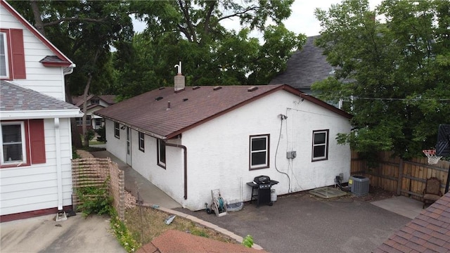 rear view of house featuring cooling unit and a patio