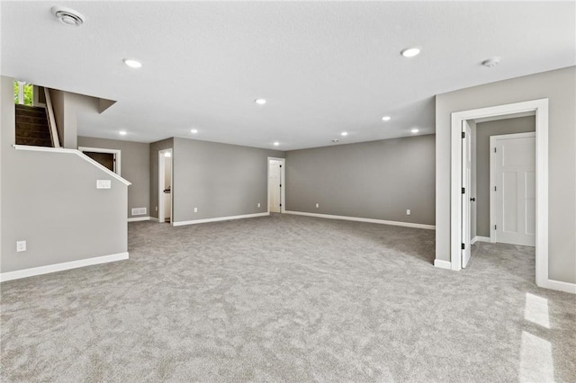 interior space with light colored carpet and a textured ceiling