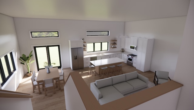 kitchen featuring stainless steel electric stove, white cabinetry, sink, and light hardwood / wood-style flooring