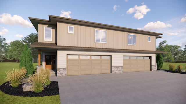 view of front of house with a garage and a front lawn