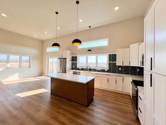 kitchen featuring backsplash, appliances with stainless steel finishes, and recessed lighting
