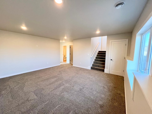 interior space featuring visible vents, baseboards, carpet, stairway, and recessed lighting