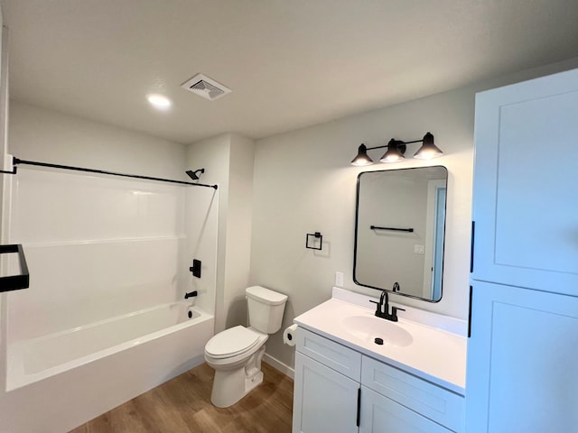 full bath with shower / bathtub combination, vanity, visible vents, toilet, and wood finished floors