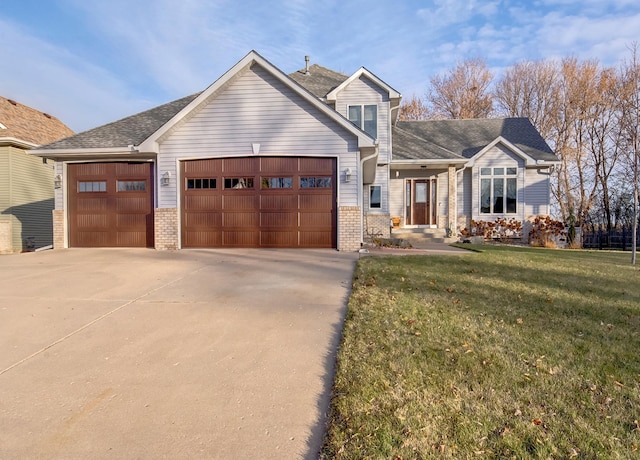 view of front of property with a garage and a front yard