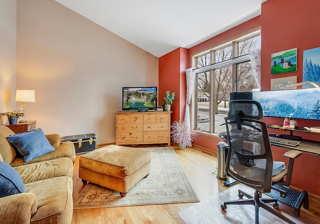 home office featuring wood-type flooring and high vaulted ceiling