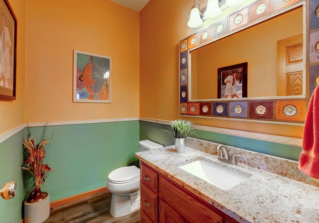 bathroom featuring vanity, hardwood / wood-style floors, and toilet