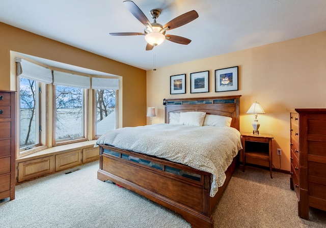 bedroom featuring ceiling fan and carpet