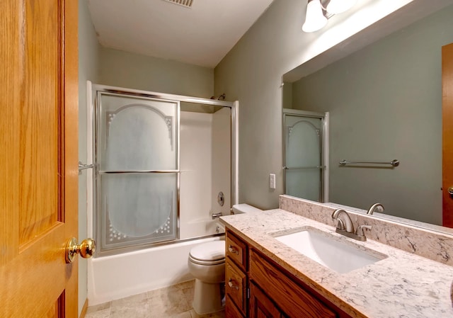 full bathroom featuring vanity, tile patterned floors, enclosed tub / shower combo, and toilet