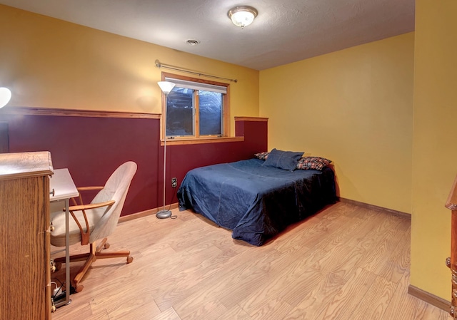 bedroom with light hardwood / wood-style flooring