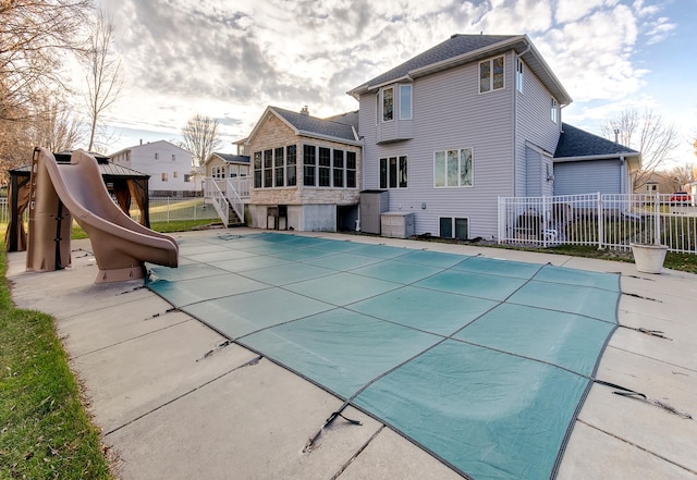 view of swimming pool with a patio, a sunroom, a gazebo, and a water slide