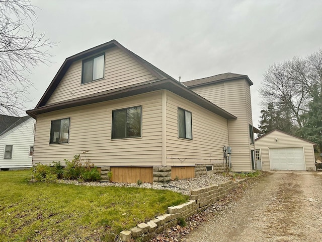 view of property exterior featuring a yard, a garage, and an outdoor structure