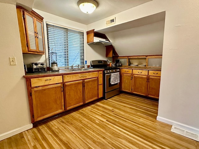 kitchen with exhaust hood, sink, light hardwood / wood-style floors, and stainless steel gas range