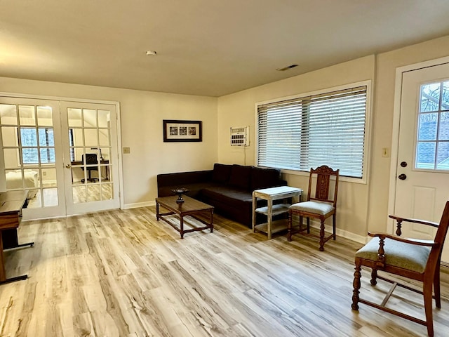 living room featuring french doors and light hardwood / wood-style floors