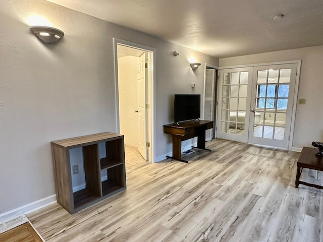 living room featuring light hardwood / wood-style flooring and french doors