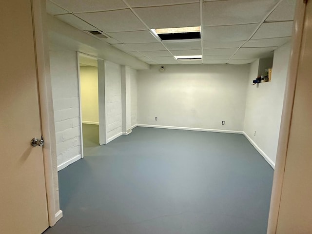 basement featuring a paneled ceiling