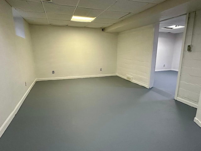 basement featuring a paneled ceiling