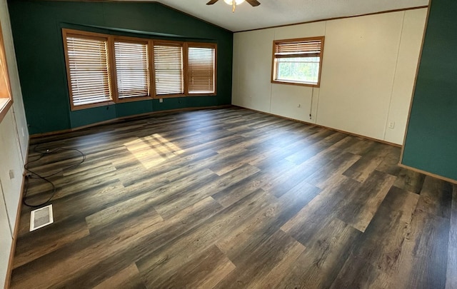 unfurnished room featuring a textured ceiling, ceiling fan, dark wood-type flooring, and lofted ceiling