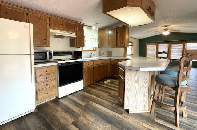 kitchen featuring a textured ceiling, lofted ceiling, and white appliances