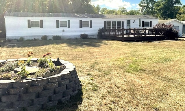 rear view of property featuring a lawn and a wooden deck