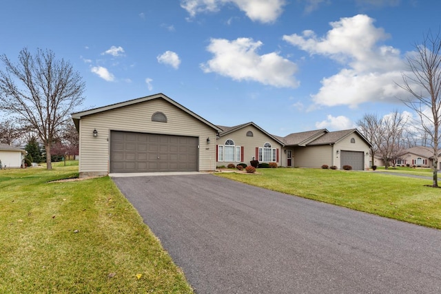 ranch-style house with a garage and a front lawn