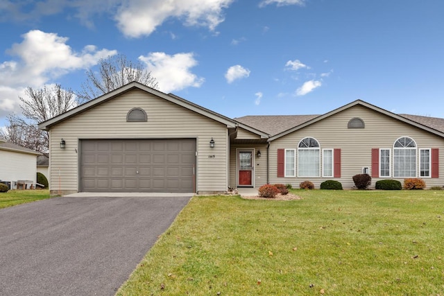 ranch-style home with a garage and a front lawn