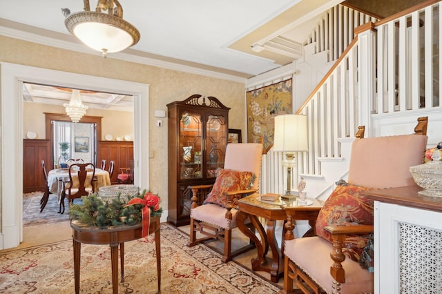 sitting room featuring a chandelier and ornamental molding